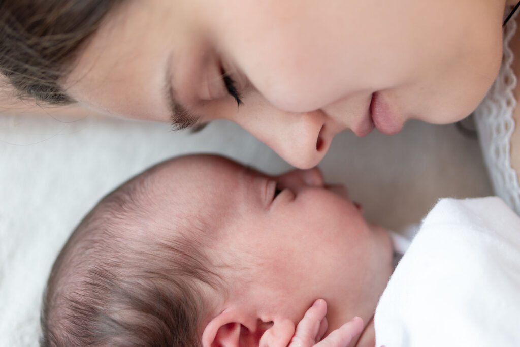 mother and a new born baby face to face